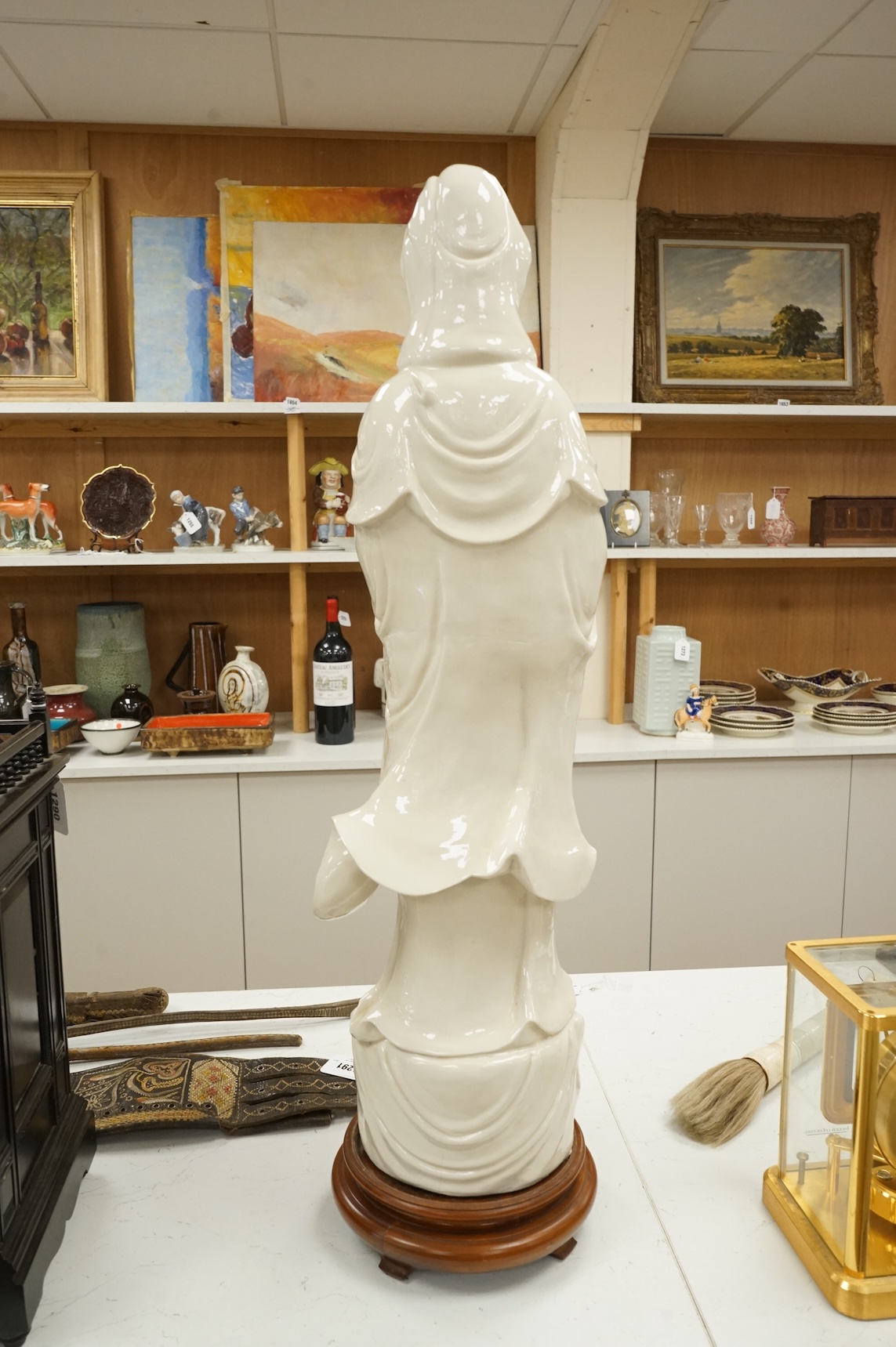 A Chinese blanc de chine figure of Guanyin, on stand, 81cm high
